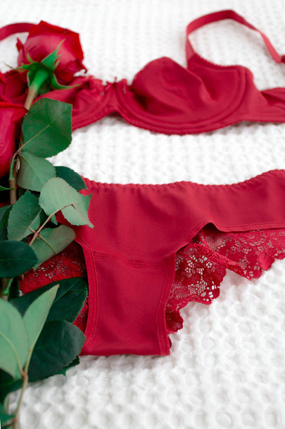 Red Underwear on White Background with Flowers - Фото, зображення