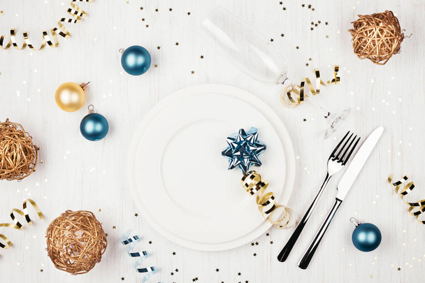 Christmas table setting with blue and golden decorations. - Photo, Image