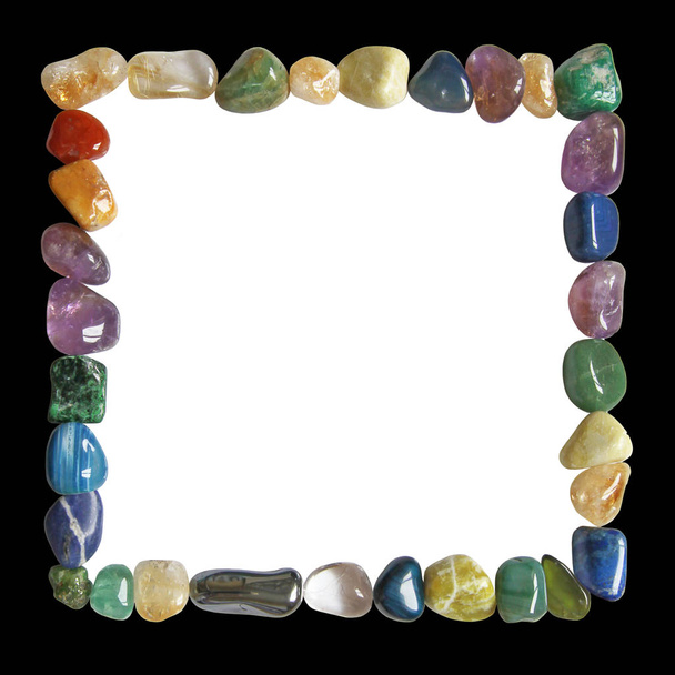 Crystal healing black and white frame - Multicoloured tumbled crystal healing stones placed in a neat square formation border with black outside and white centre - Photo, Image