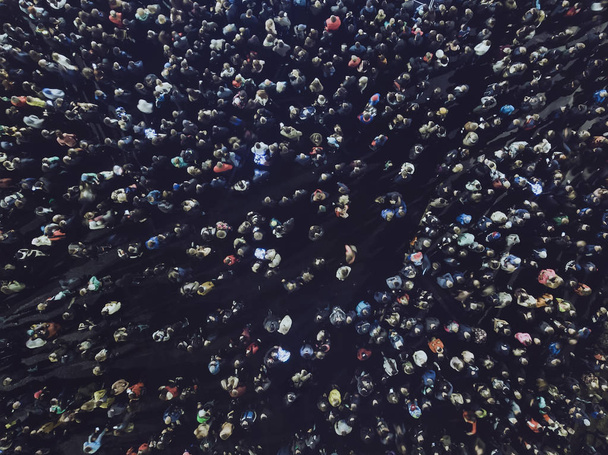 An aerial shot of the people gathered for an event. Crowed open-air meeting of people shot from a height. A mass of people gathered to celebrate an event. Open-air night festival.City merrymaking - Photo, Image