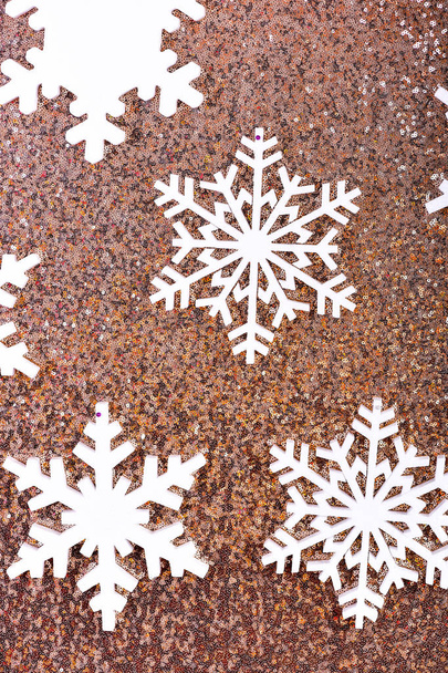 Snowflakes on shimmering festive background. Snowy background concept. Winter theme background with white snowflakes. Snowflakes on glitter shining surface - Fotoğraf, Görsel