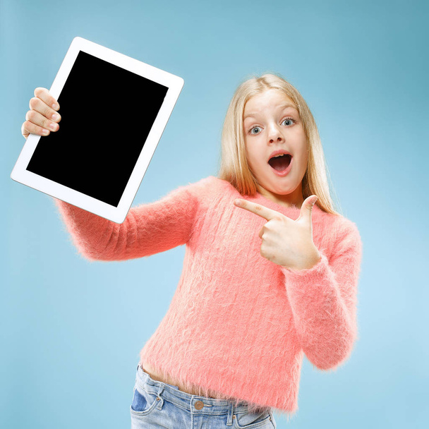 Little funny girl with tablet on blue background - Zdjęcie, obraz