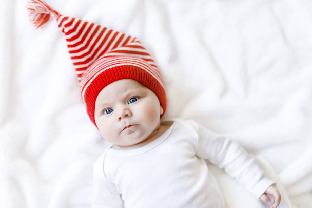 Cute adorable baby child with Christmas winter cap on white background - 写真・画像