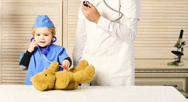 Treatment and childhood concept. Male in surgical coat - Zdjęcie, obraz