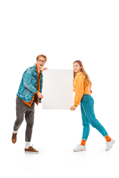 excited stylish hipster couple holding empty banner isolated on white - Foto, imagen