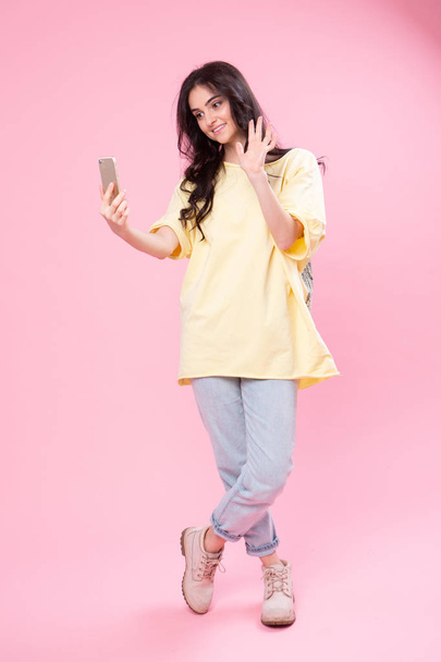 Life stream video selfie mania! Studio photo portrait of attractive cheerful fun joy joyful girl making taking self picture posing for camera isolated pastel background copy space - Photo, Image