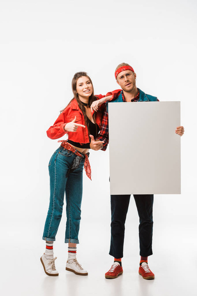 young hipster couple pointing at empty banner isolated on white - Fotografie, Obrázek