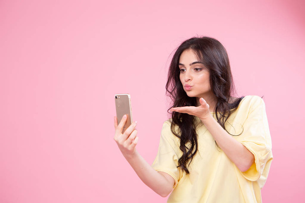 Life stream video selfie mania! Studio photo portrait of attractive cheerful fun joy joyful girl making taking self picture posing for camera isolated pastel background copy space - Photo, image