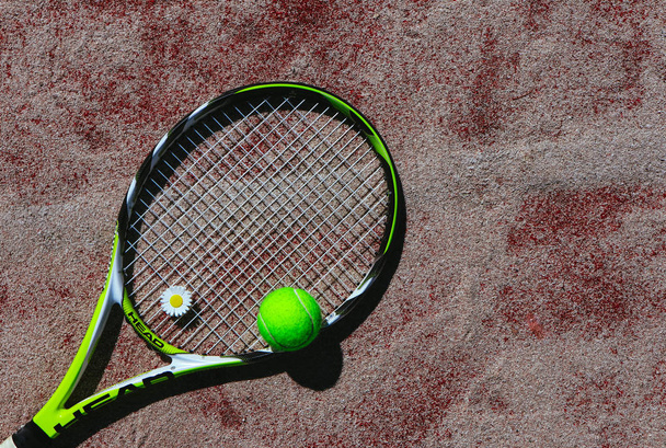 France, Paris - 15 August 2018: Tennis racket Head and a ball on the tennis court background. - Φωτογραφία, εικόνα