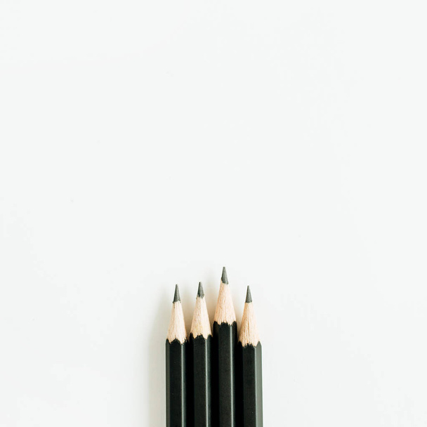 Black pencils isolated on white background. Flat lay, top view. - Foto, Imagem