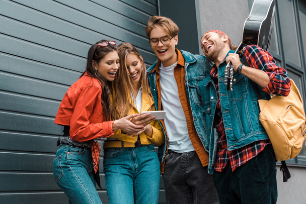 rire hipsters avec guitare en utilisant smartphone ensemble sur la rue
 - Photo, image