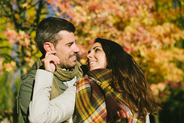 Cute couple of lovers in autumn outdoor. Love and caring relationship concep. - Photo, Image