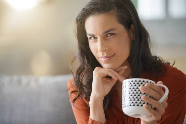 Portrait of attractive brunette woman drinking tea - Photo, image