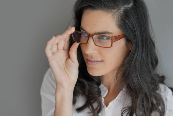 Portrait of attractive brunette woman with eyeglasses, isolated - Foto, Bild