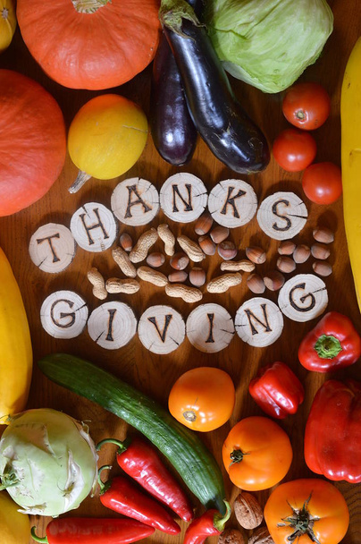 fruits and vegetables with burned wood showing the word thanksgiving - Photo, Image