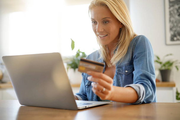 Blond woman at home shopping online - Photo, Image