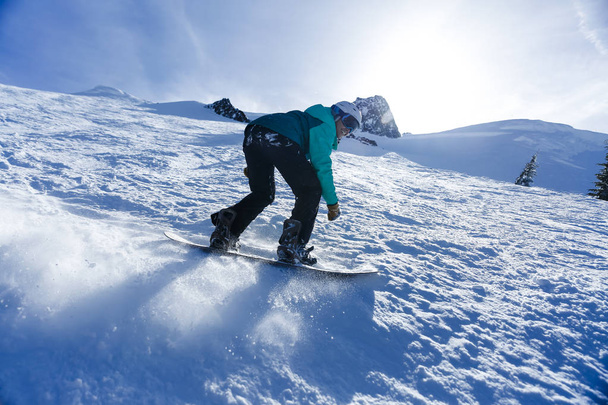 Mixed race woman snowboarding - Photo, Image