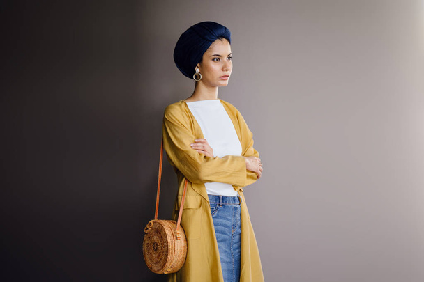 Fashion portrait of a tall, slim, young and attractive Malay Muslim woman wearing fashionable clothing and a turban - Valokuva, kuva