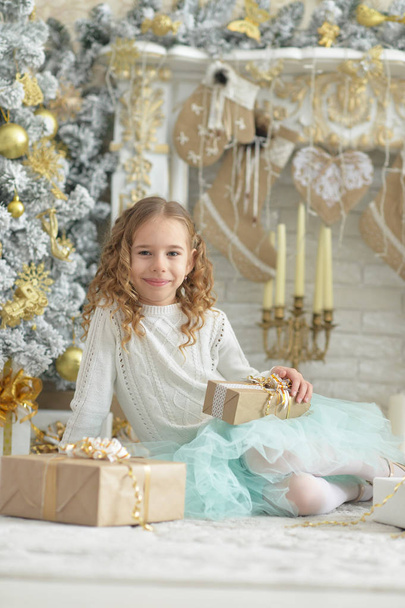 Portrait of happy girl  sitting  with Christmas presents - Fotó, kép