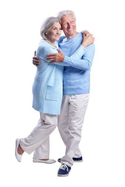 Portrait of a happy senior couple hugging on  white background - Foto, afbeelding