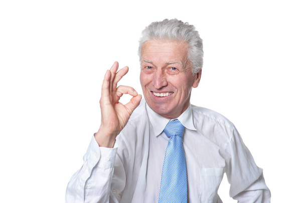 close up portrait of senior businessman in formal wear showing ok sign isolated on white background - Valokuva, kuva