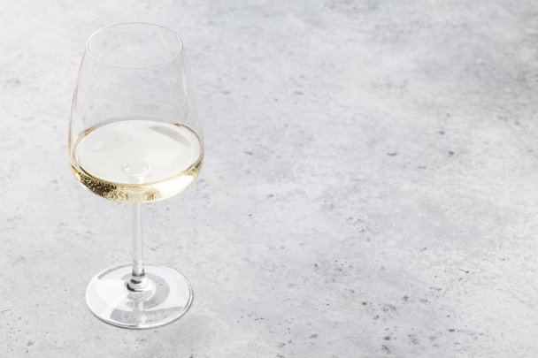 White wine glass on stone backdrop. With space for your text - Photo, Image