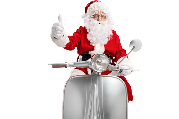 Santa Claus on a scooter showing thumbs up isolated on white background - Valokuva, kuva