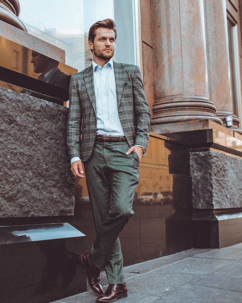 full length of stylish Caucasian gentleman in tweed suit jacket posing at building in street  - Foto, Imagem