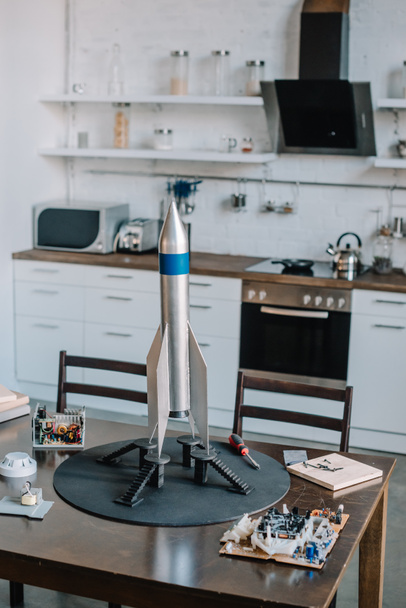 rocket model and tools for designing on table in kitchen - Fotografie, Obrázek