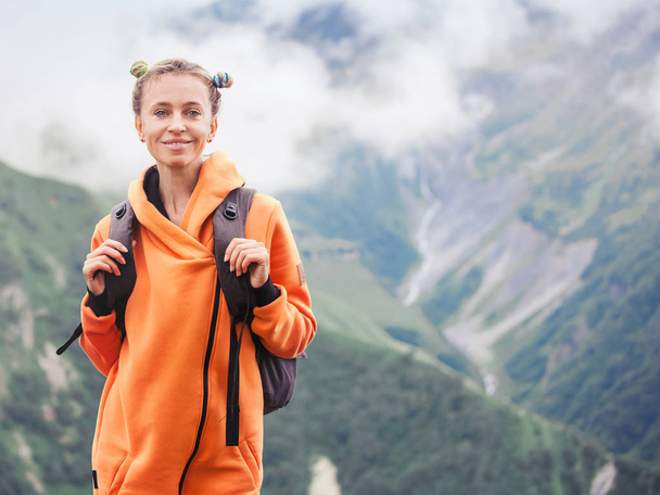 Man at the top of the mountain. Woman tourist with backpack in the mountains - 写真・画像