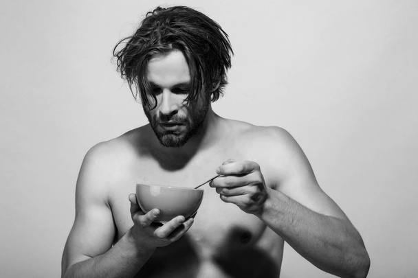 bearded naked sexy man has breakfast in the morning - Foto, afbeelding