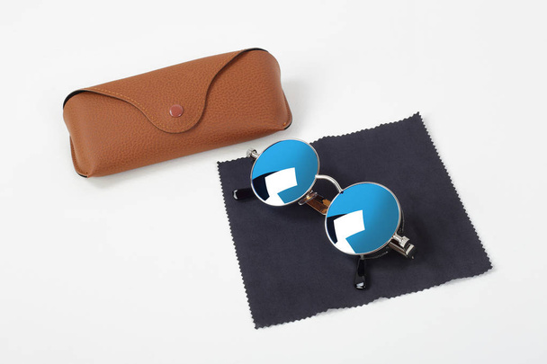 Clothes, shoes and accessories - Sunglasses, case and napkin on a white background. - Photo, Image