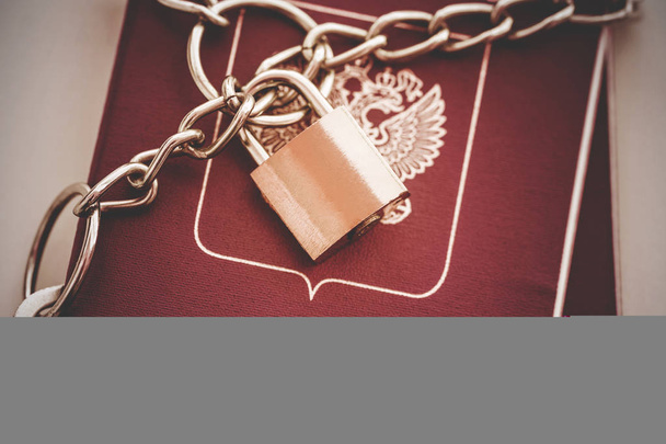 Russian Passports covered with a chain with a golden Lock. Toned - Photo, Image