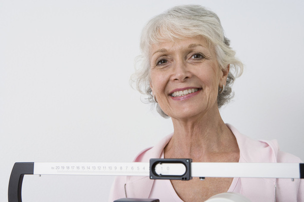 Senior Female Patient With Weight Scale - Foto, Bild