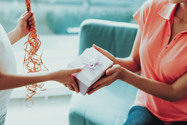 Close-up. Little Daughter Gives Present To Mum. Family Relationship. Active Holiday. Beautiful Moment. Surprise To Parent. Happy Childhood. Postcard In Hands. Gift Ribbon On The Box. - Fotó, kép
