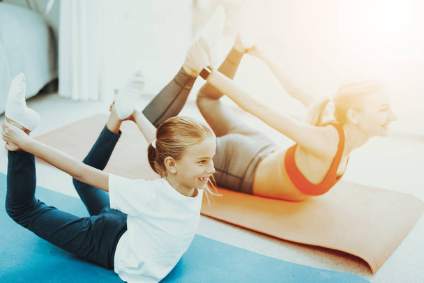Mum And Daughter Training Stretch. Heel Touch. Yoga Concept. Beauty And Grace. Active Lifestyle. Relaxing Together. Doing Fitness At Home. Holiday Leisure. Body Balance. Basket Exercise. - Zdjęcie, obraz