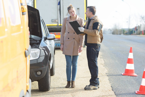 woman talking to breakdown assistant on the roadside - Photo, Image