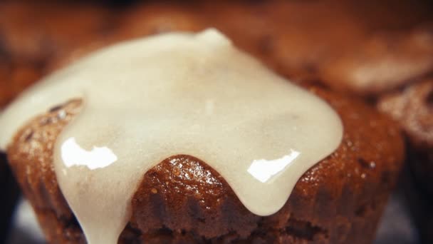 Slow motion muffins pour glaze close up - Felvétel, videó