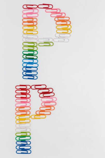 Alphabet P made from color paper clips on white background. - 写真・画像