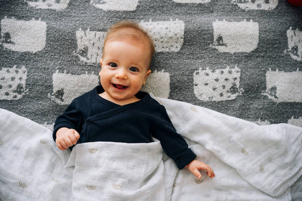 Cute funny little boy on a blanket - Valokuva, kuva