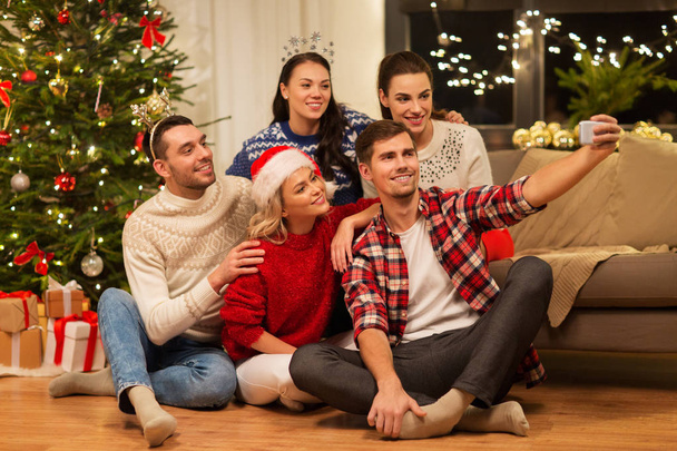 friends celebrating christmas and taking selfie - Photo, image