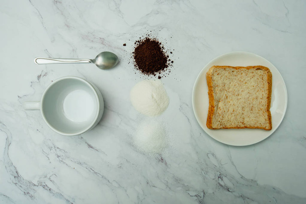 hot coffee and whole wheat bread on marble background - Foto, immagini