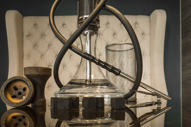 Beautiful glass hookah on a wooden table in a hookah bar	 - Photo, image