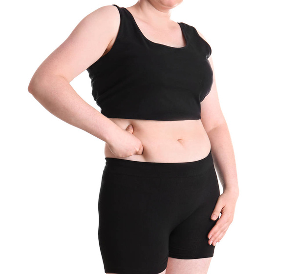 Overweight woman touching belly fat before weight loss on white background - Zdjęcie, obraz