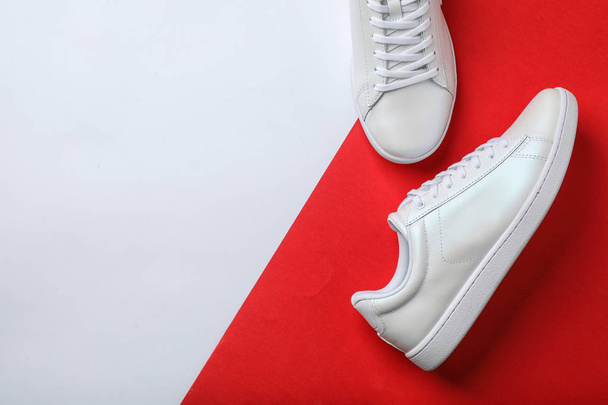 Pair of sneakers on color background, flat lay. Space for text - Fotó, kép