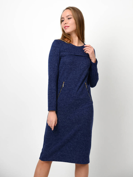 Young beautiful woman posing in new casual winter blue dress - Foto, afbeelding