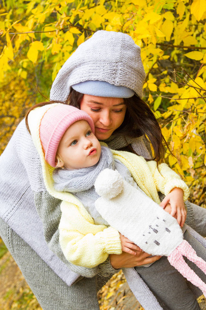 Mom with her daughter on the background of the autumn landscape - Фото, зображення