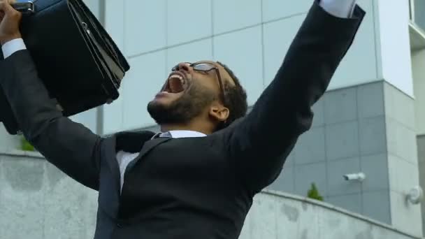 African american man shouting and dancing from happiness, success, promotion - Video