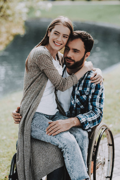 Girl on Wheelchairs with Boyfriend in Summer Park. Disabled Young Woman. Woman on Wheelchair. Relaxing in Summer Park. Picnic in Summer Park. Recovery and Healthcare Concepts. Cheerful People. - Фото, изображение