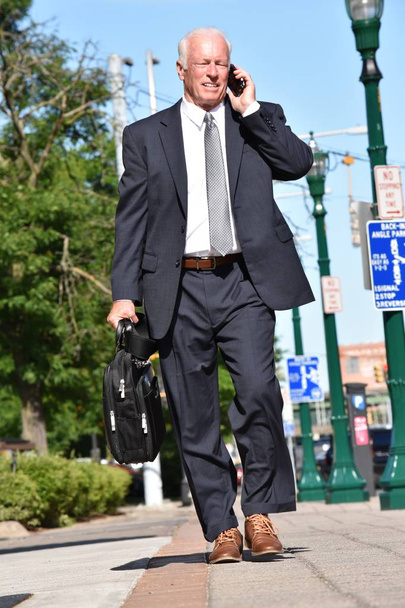 Adult Senior Investor Using Cell Phone And Happy Walking - Фото, изображение